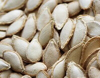 many whitish dried Pumpkin Seeds are piled together