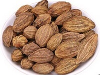 many brownish herbs of Terminalia Fruit are piled in a plate
